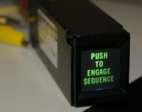 an old timey button labeled 'push to engage'